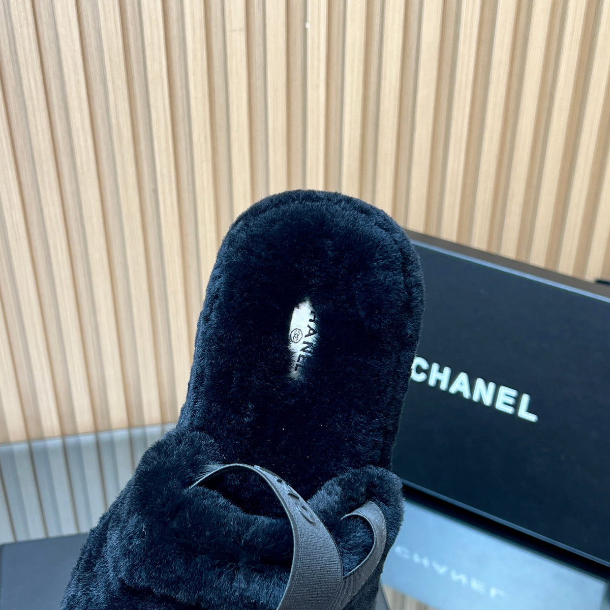 CHANEL 25S THICK-SOLED FURRY SLIPPERS WITH ELASTIC STRAPS IN BLACK FUR