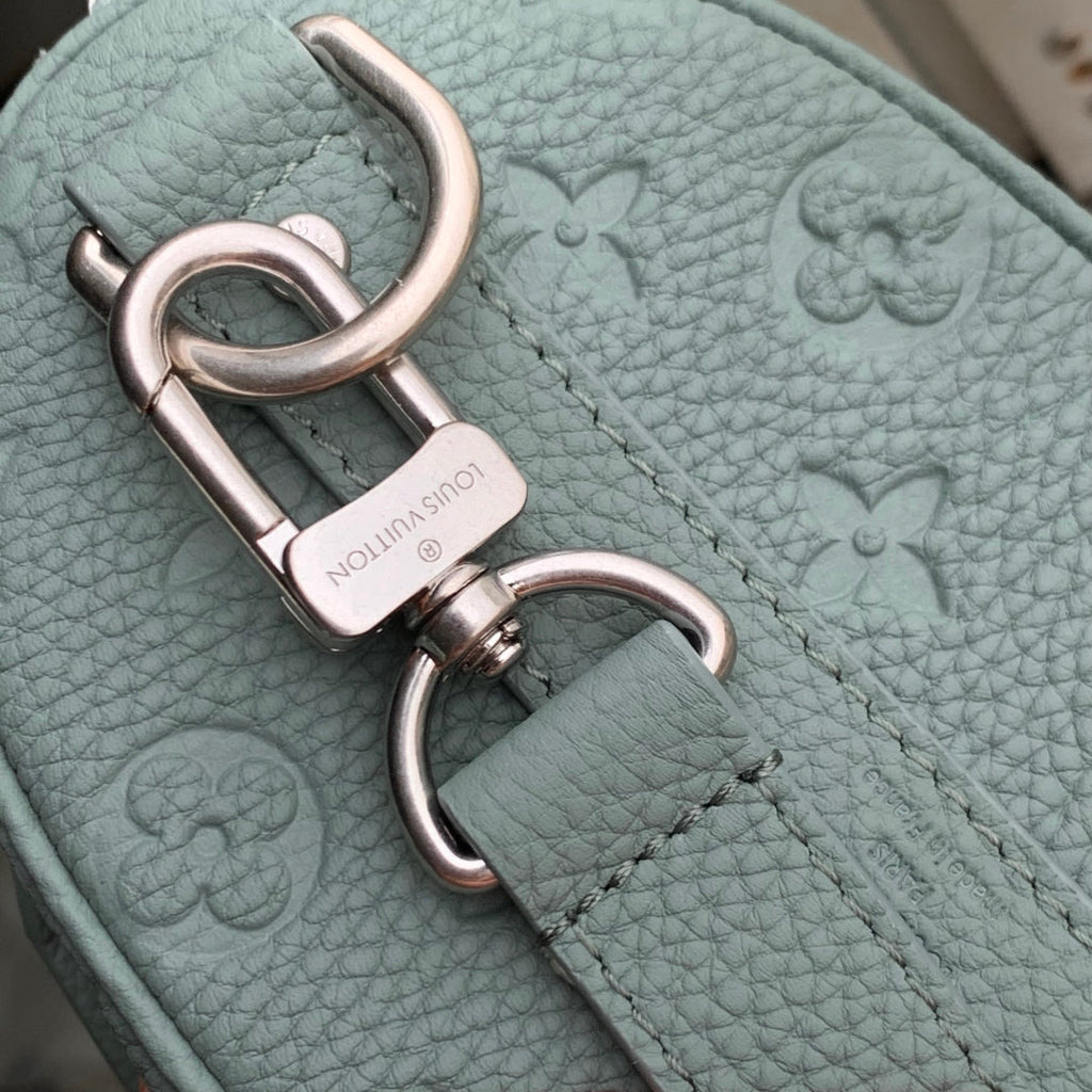 LOUIS VUITTON KEEPALL BANDOULIÈRE 25 BAG IN MISTY LAKE GREEN MONOGRAM TAURILLON CALFSKIN
