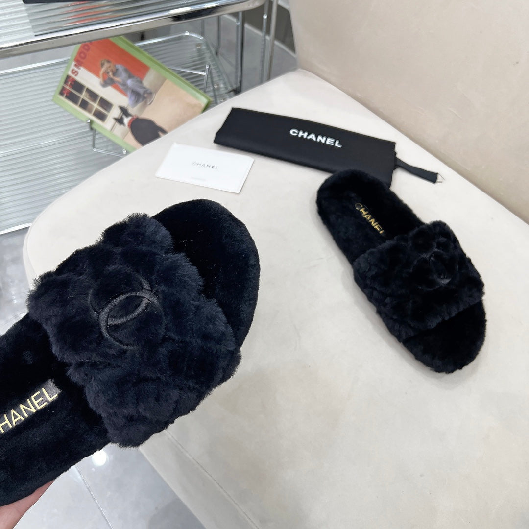 CHANEL 25S FUR SLIPPERS WITH EXPOSED-STITCH STRAPS IN BLACK